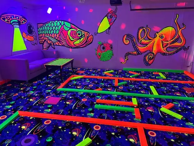 Glow-in-the-dark mini golf game room built into a Florida short-term rental owned by Brian Bowman